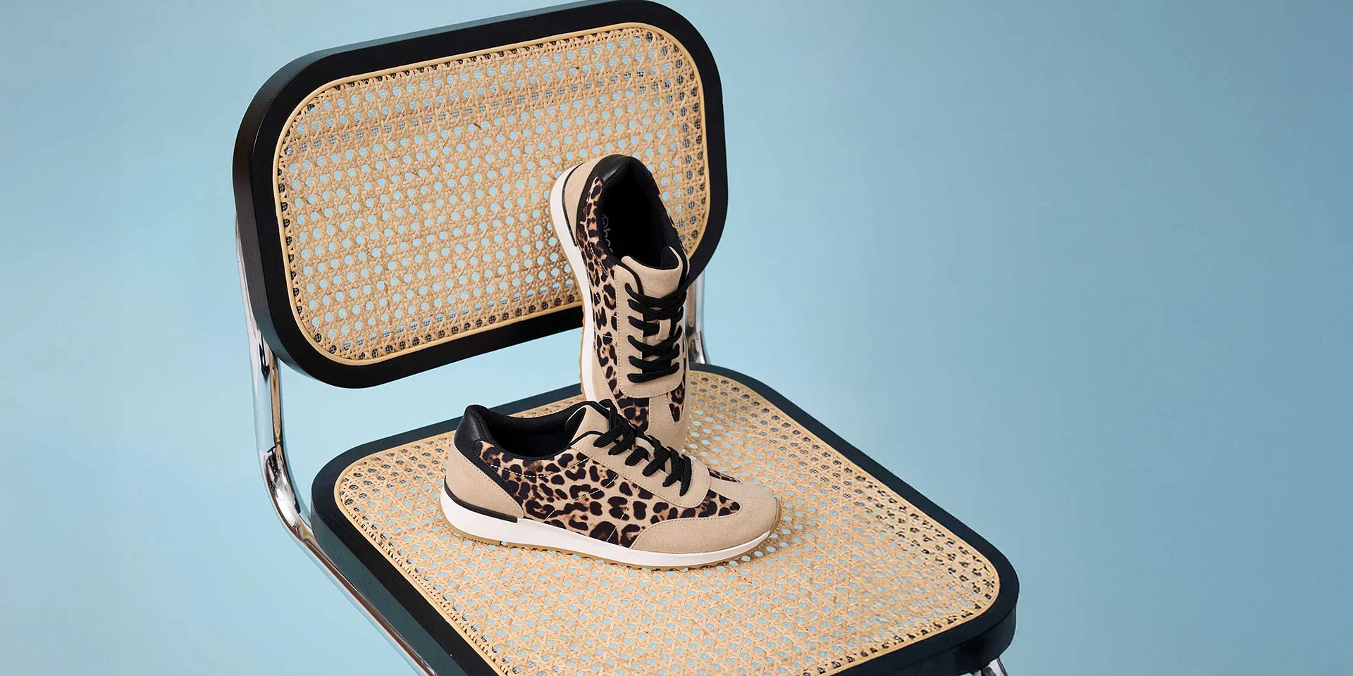 Stilsäkra sneakers med leopardmönster på en flätad stolsits.