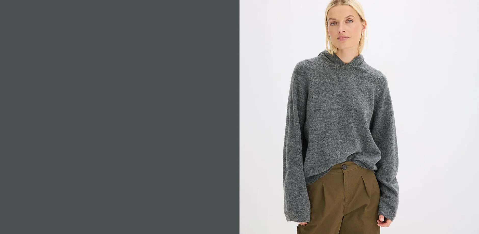 Stilfull look med en bekv&auml;m, gr&aring;, stickad huvtr&ouml;ja och moderiktiga, olivgr&ouml;na byxor med gubbveck.