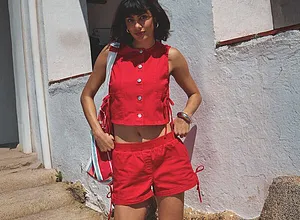 Ljusröd sommarlook: ärmlös topp med knappar och korta shorts. Snyggt och lätt.
