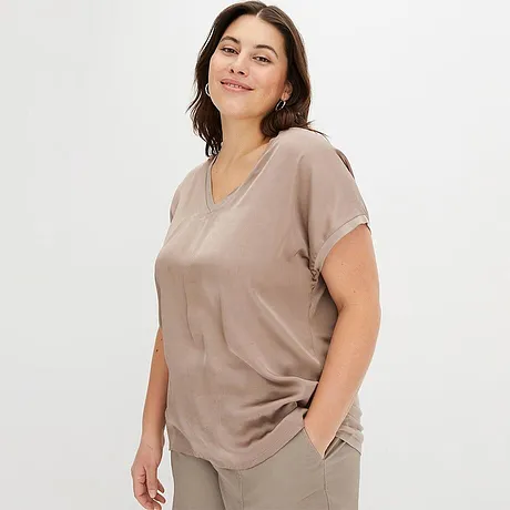 Bekväm, beige topp med V-ringning och korta ärmar.