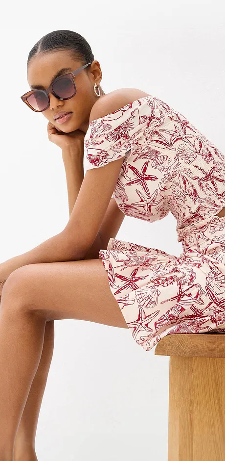 Somrig off-the-shoulder-outfit med rött och vitt mönster.