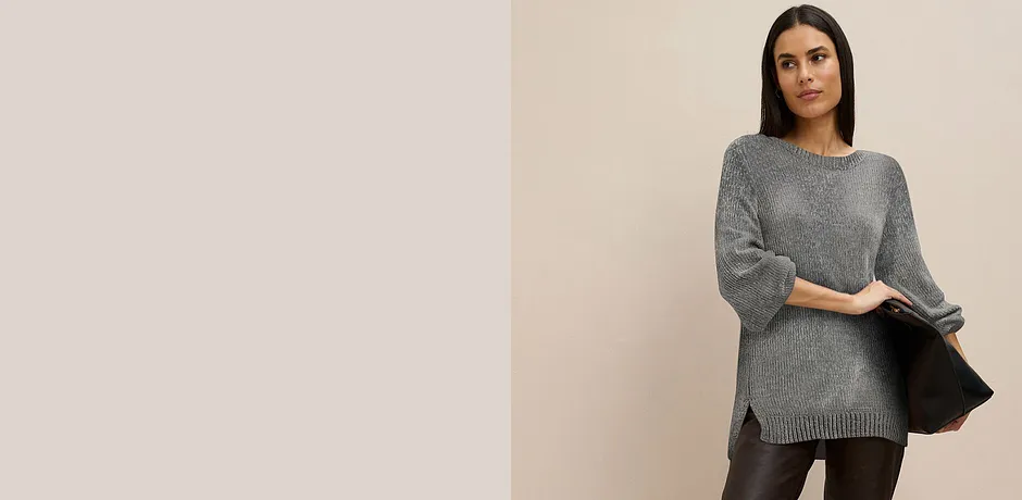 Grå långärmad tröja kombinerad med mörka byxor.

