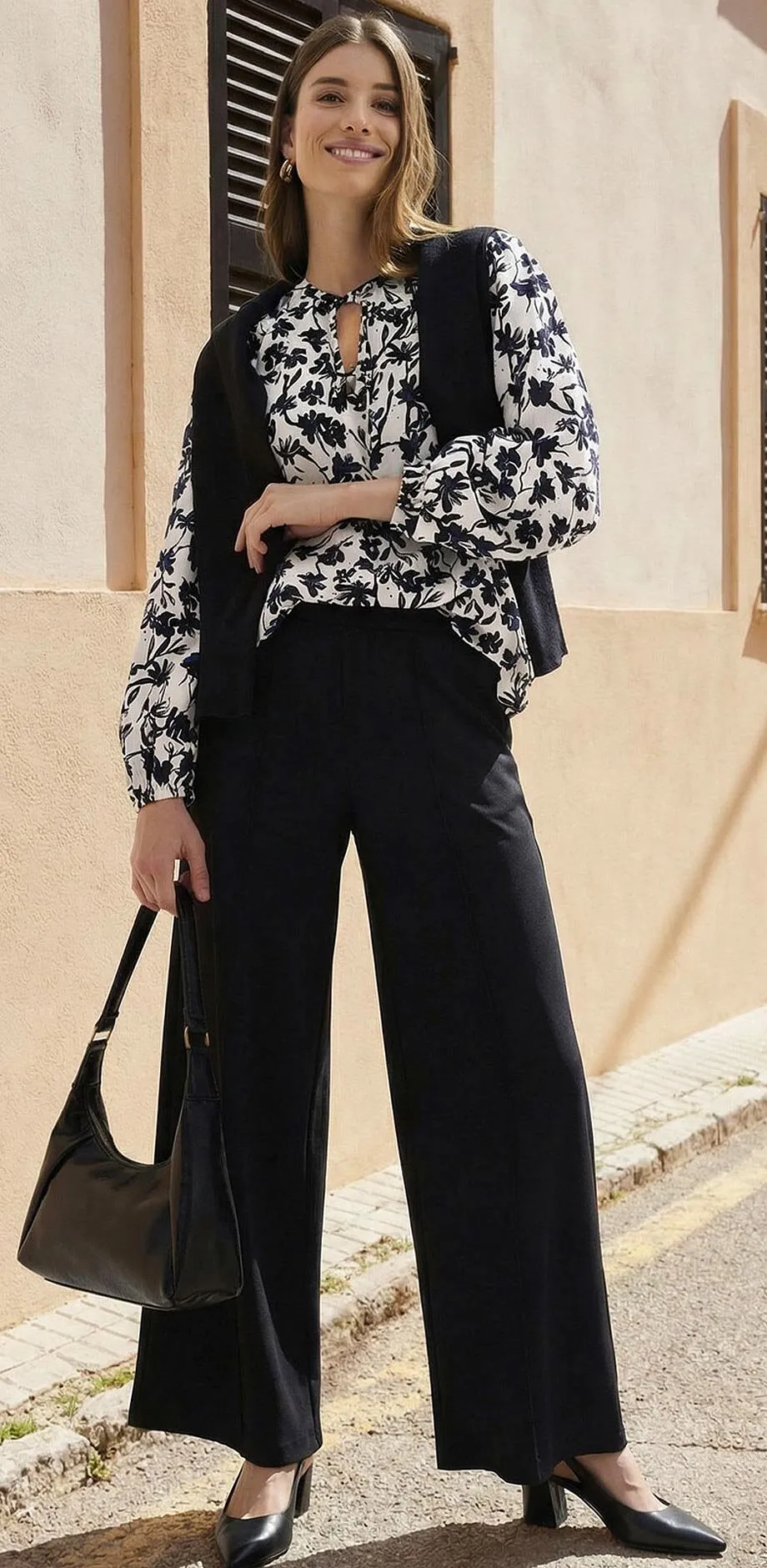 Svarta byxor kombinerat med m&ouml;nstrad blus i svartvitt.

