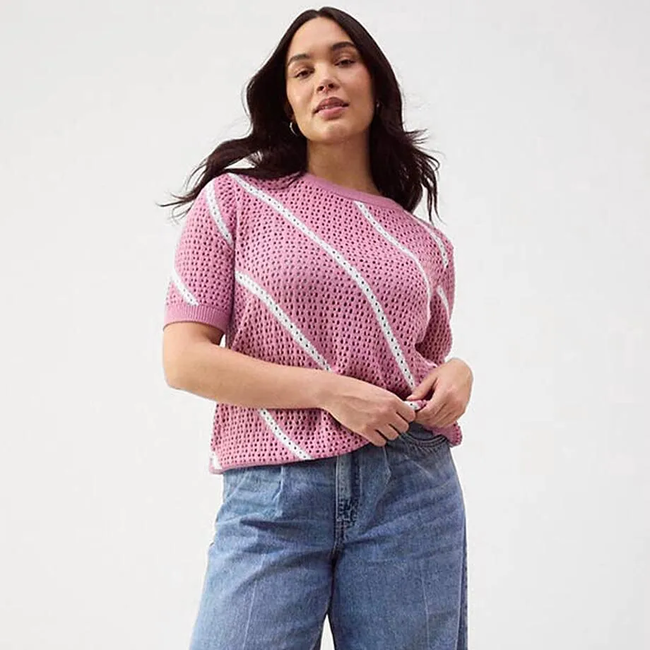 Ledig, stickad tr&ouml;ja i rosa kombinerad med vida jeans.