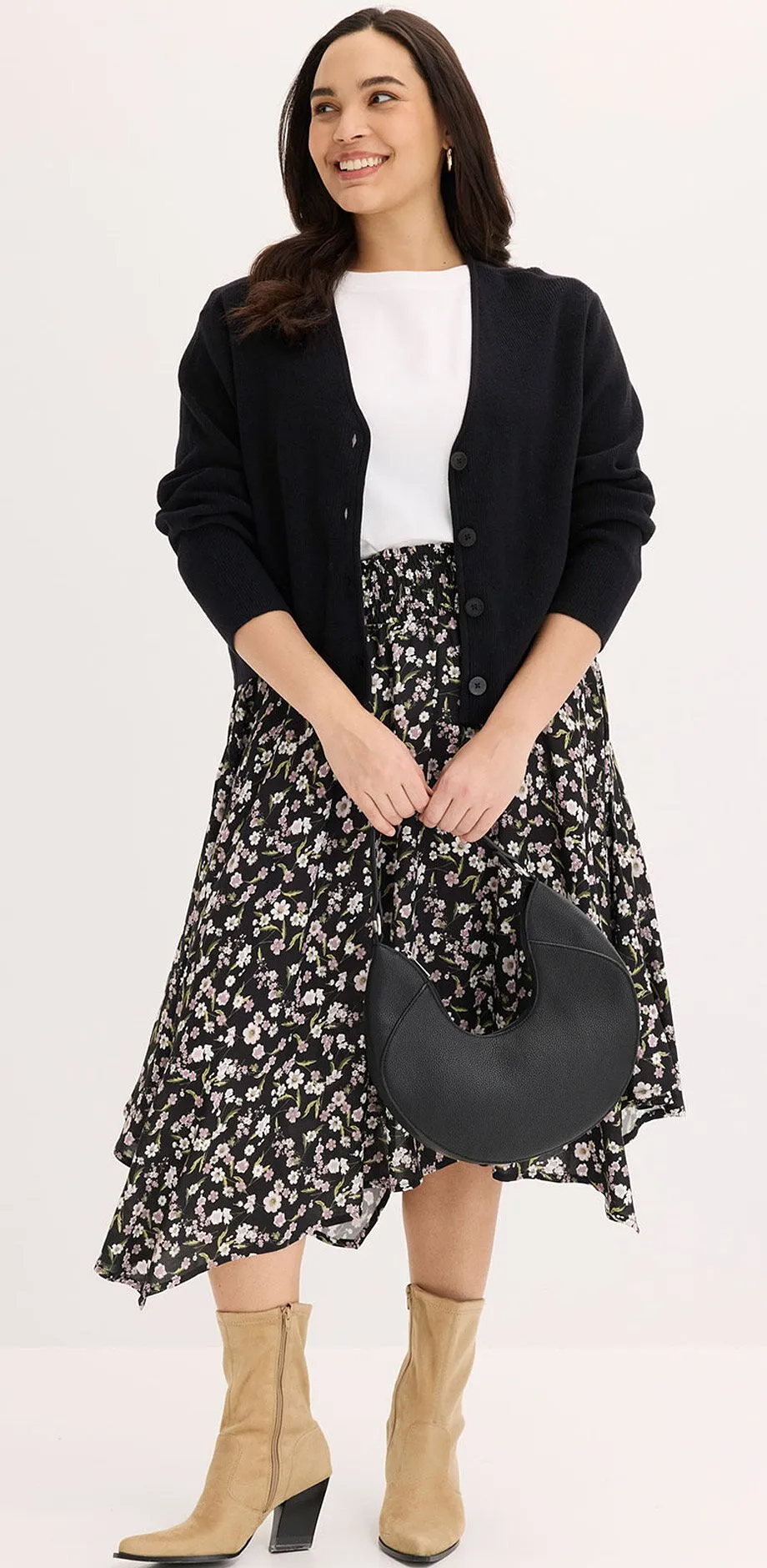 Svart kofta, vit t-shirt och svartvit m&ouml;nstrad midikjol.

