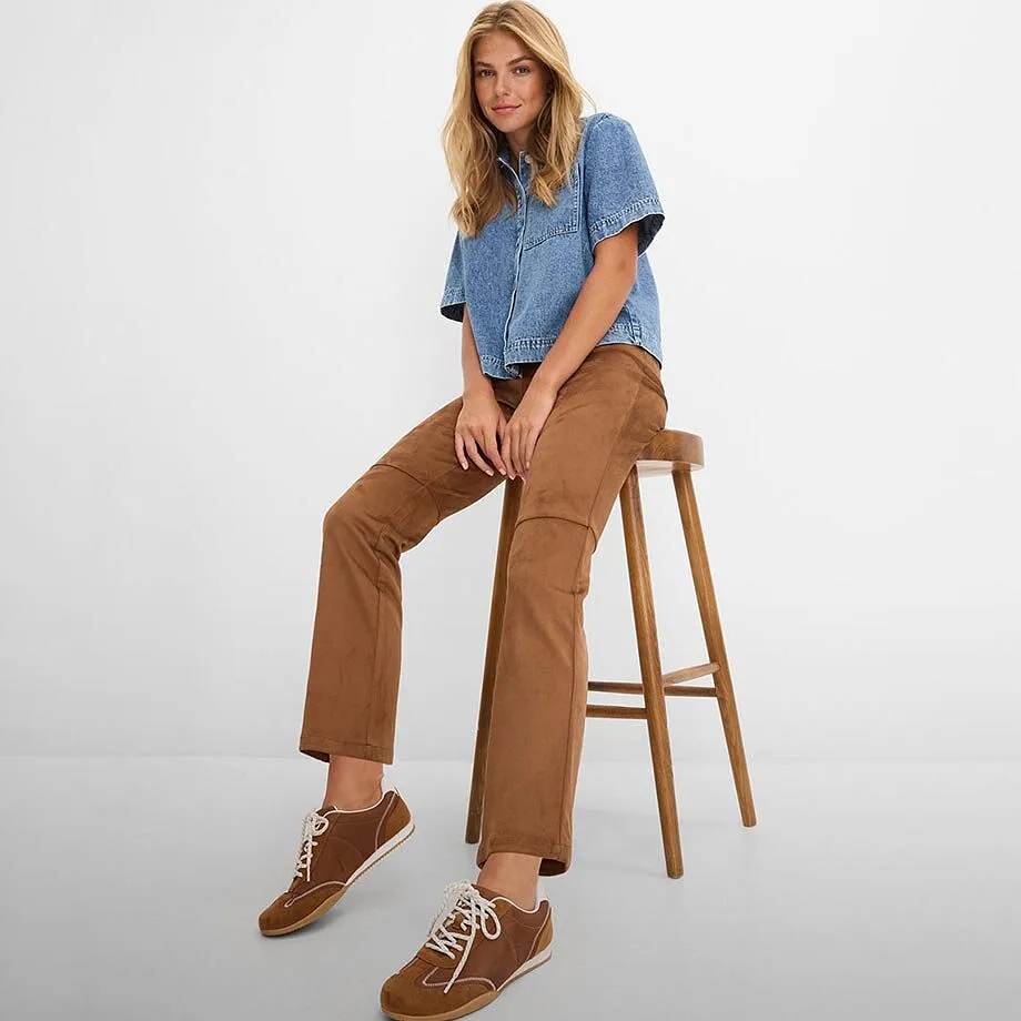 Ledig denimskjorta, bruna byxor och matchande sneakers.