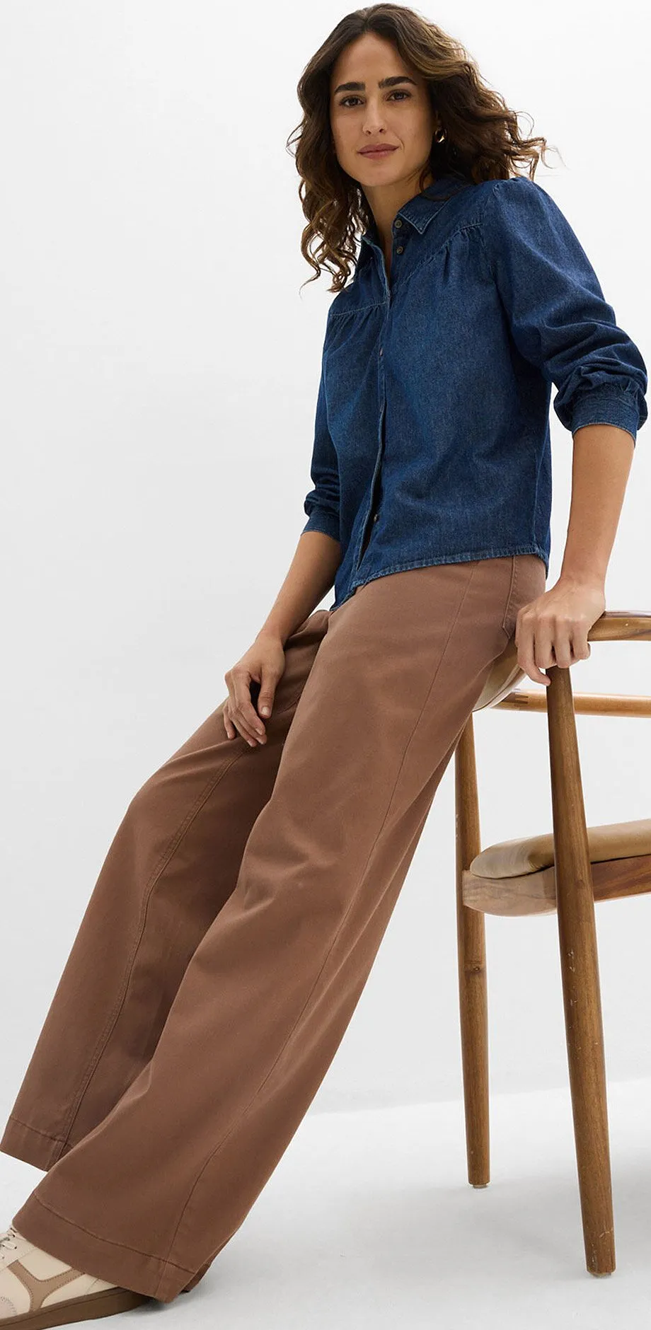 M&ouml;rkbl&aring; jeansskjorta kombinerat med bruna byxor och ljusa sneakers.

