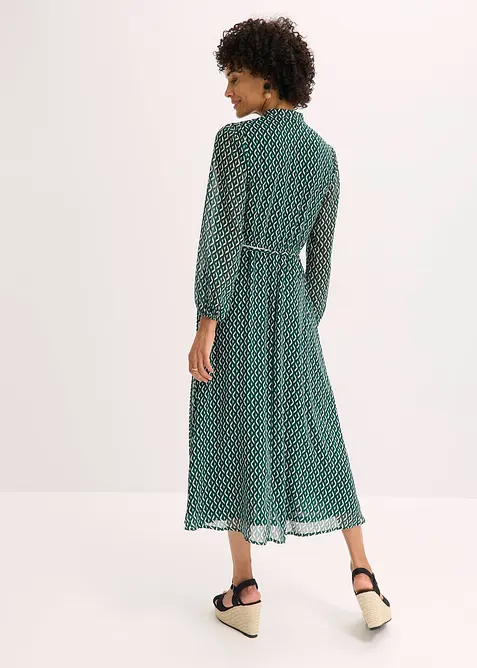 Mönstrad chiffongklänning med kontrasterande passpoaler, bonprix